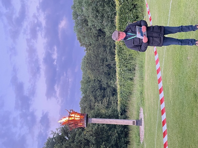 Councillor reading Tribute by lit beacon